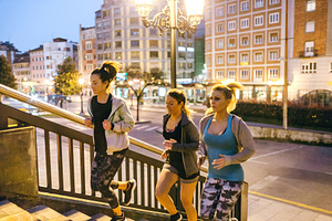 Women friends training running up stairs in city at night, a Sports & Recreation Photo by davidpereiras