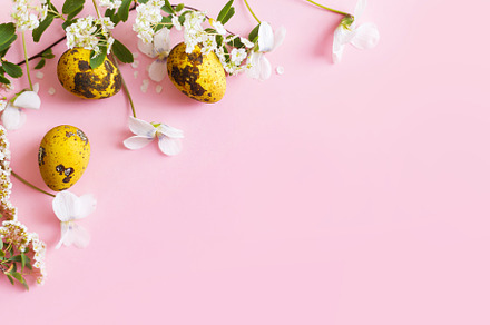 Easter flat lay. Stylish easter eggs and spring flowers on pink