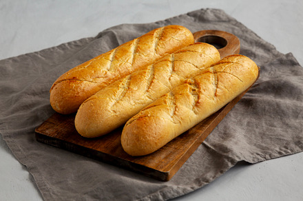 Homemade French Baguette with Garlic Filling on a wooden board,, a Food & Drink Photo by LiudmylaChuhunova