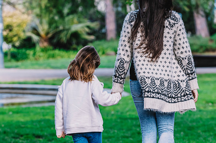 Rear view of a mother with her baby. Mom and daughter in an autumn park, a Person Photo by 2Design
