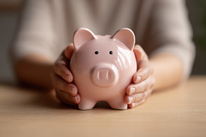 Holding a piggy bank with both hands, a Photo by Beautiful things