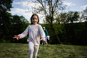 Young girl joyfully running in the park on a sunny day, a Person Photo by AS photostudio