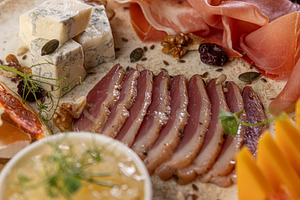 Close up of elegant charcuterie board, a Photo by Grafvision photography