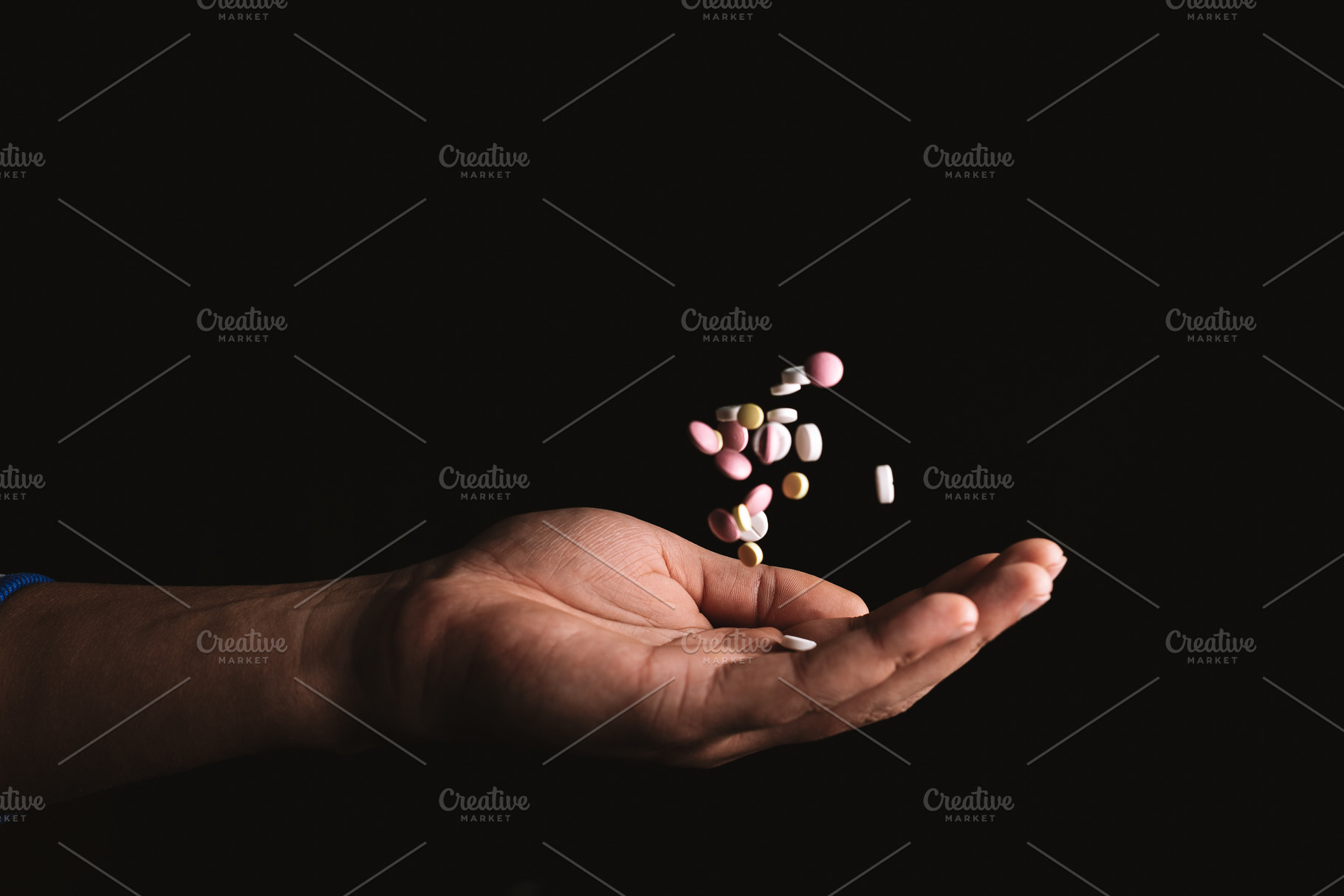 pills in hand on black background, a Background Photo by Rov.7