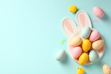 Easter rabbit shaped plate with colorful Easter eggs on blue background. Happy, a Holiday Photo by photoguns