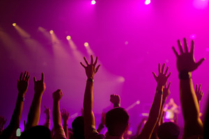 Music band crowds raising hands up in the air selective focus containing