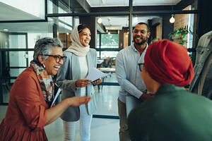 Group of happy businesspeople laughing cheerfully in an office, a Person Photo by Jacob Lund