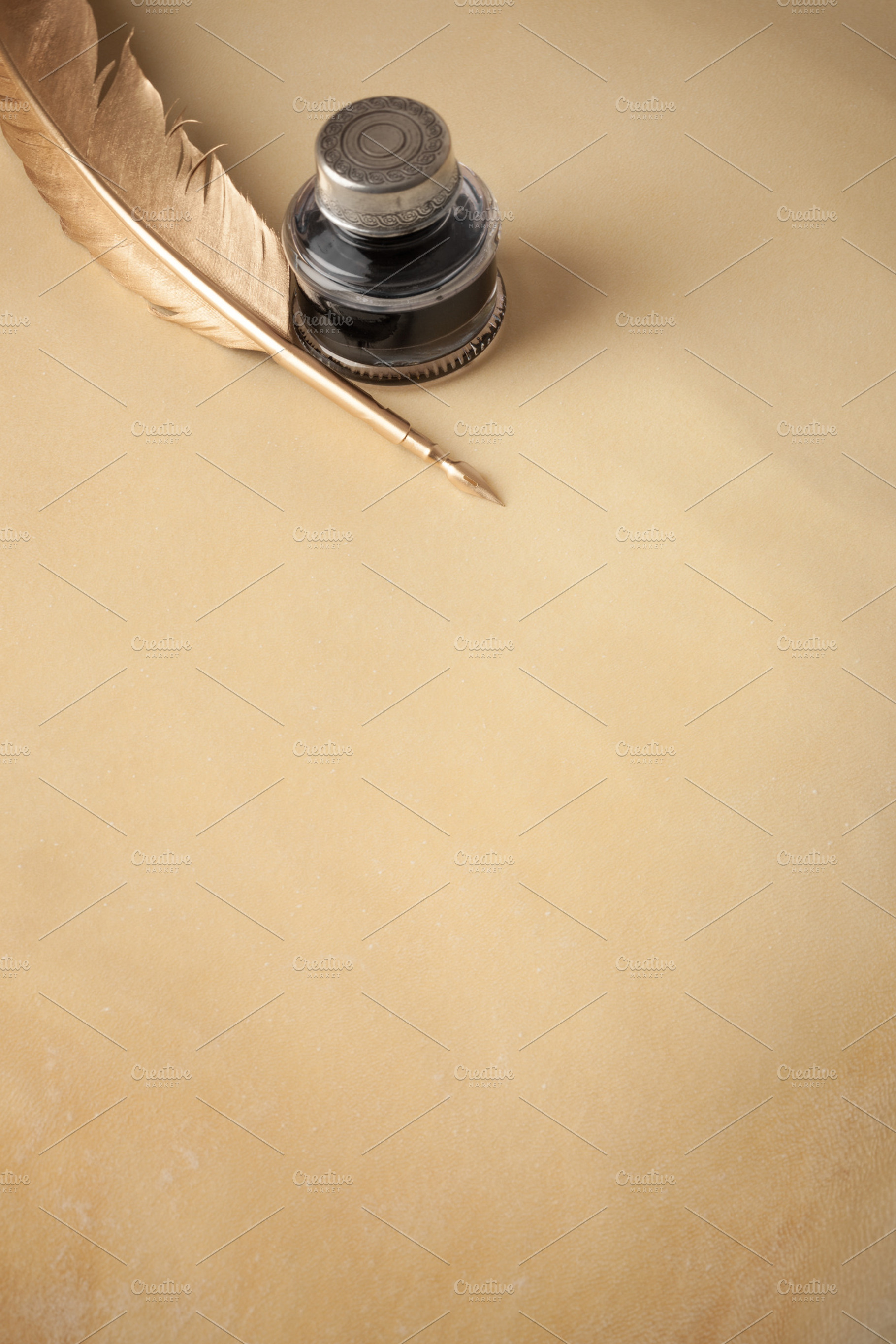 Golden quill pen on parchment, a Photo by Ernesto Solla