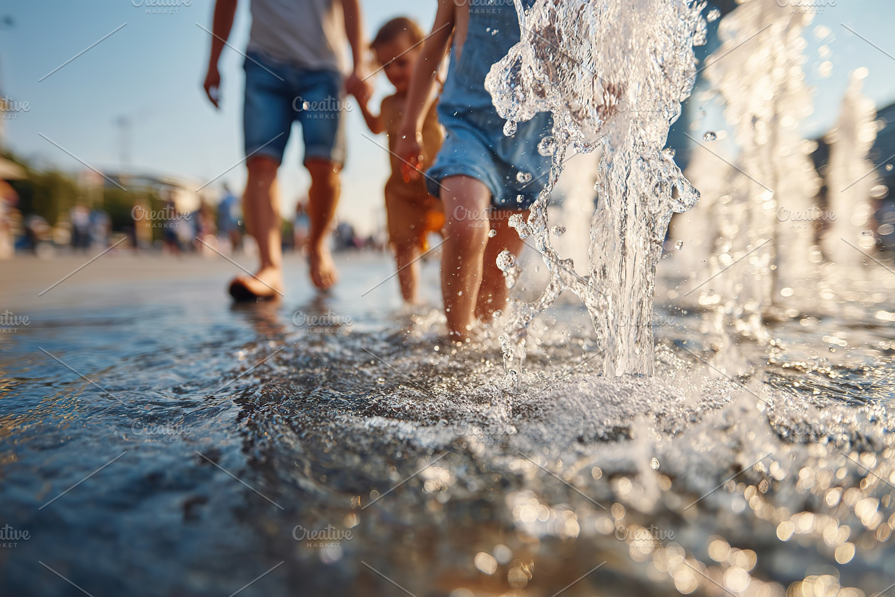 Joyful moments by the city fountain on a sunny afternoon with playful children, a Photo by AlyaAnd