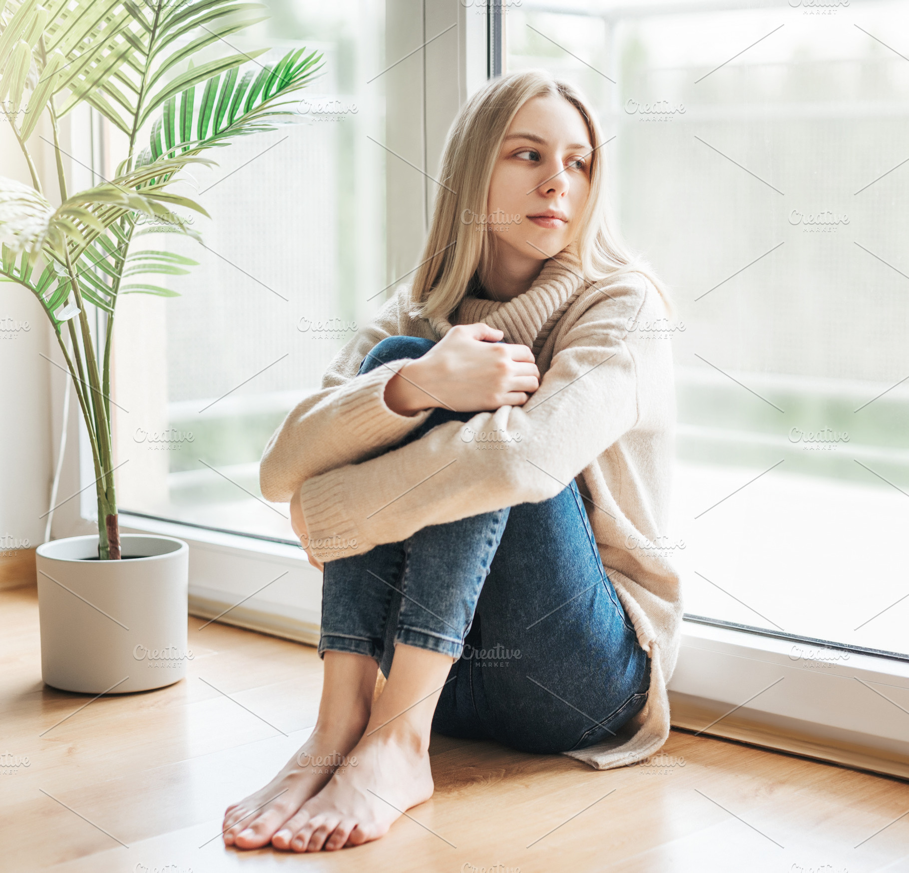 Sad girl near window thinking about something, a Person Photo by Olena Rudo