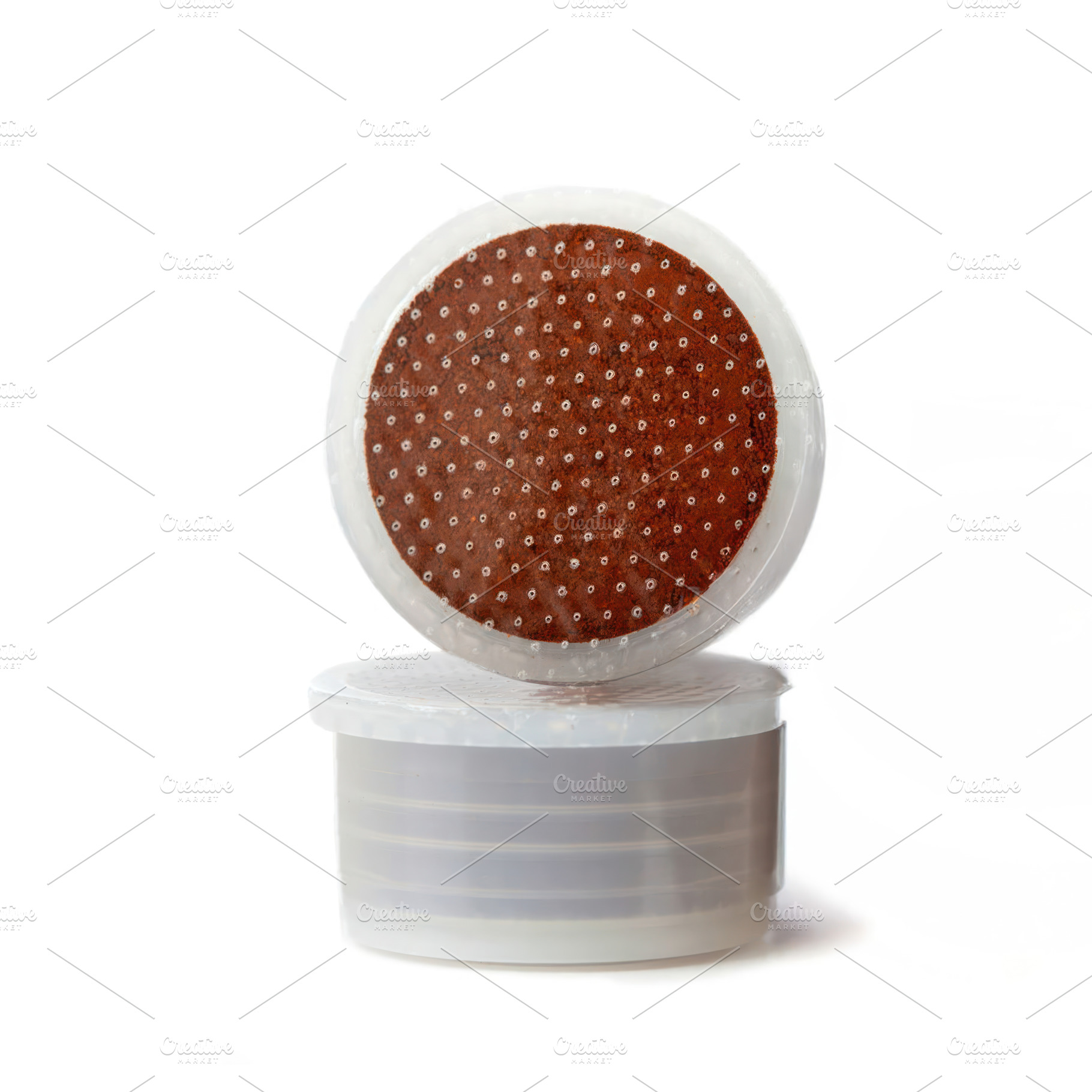 Two coffee pods balancing on white background, a Food & Drink Photo by Antonio Gravante Market