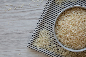 Uncooked White Organic Basmati Rice in a Bowl, top view. Copy sp, a Food & Drink Photo by LiudmylaChuhunova