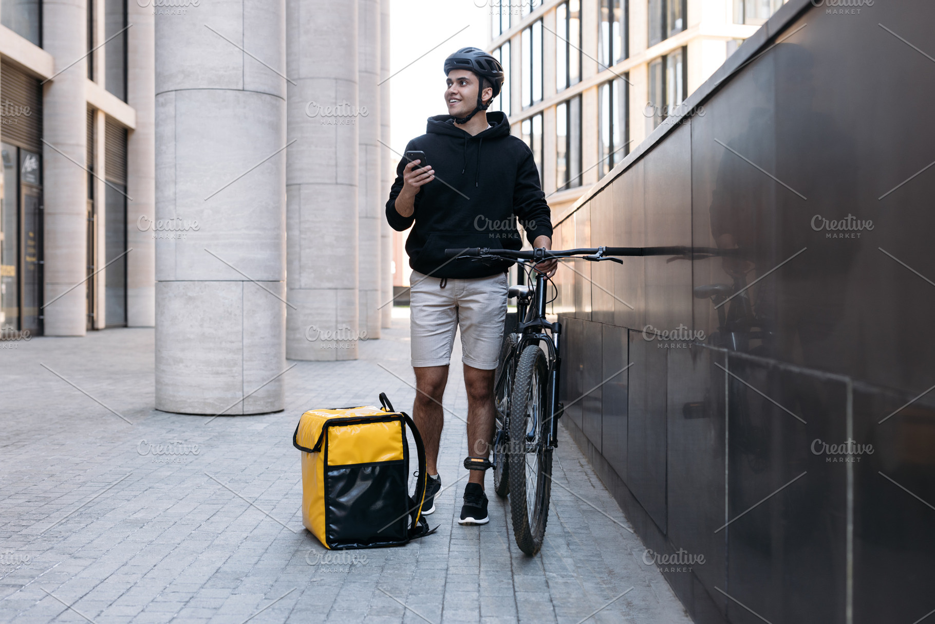 Smiling male courier standing, a Transportation Photo by Artem Varnitsin