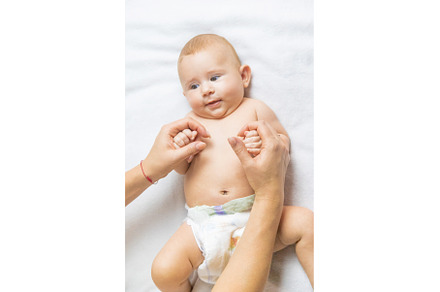 Mother massage baby on the bed, a Person Photo by yanadjana