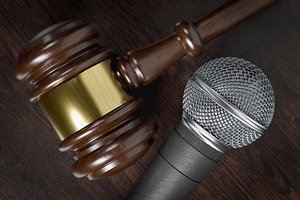 Gavel and Microphone on Wooden Table, a Photo by Andy Dean Photography