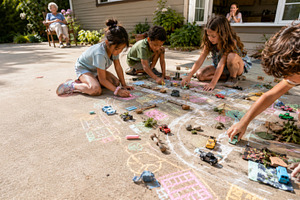 Children playing outside with toy ca, a Photo by Dvoevnore photos