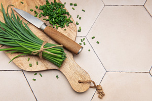 Fresh chopped chives on wooden cutting board, a Food & Drink Photo by Olena Rudo