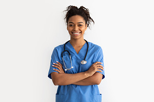 Portrait of black doctor looking at camera with folded arms, a Photo by Prostock-Studio
