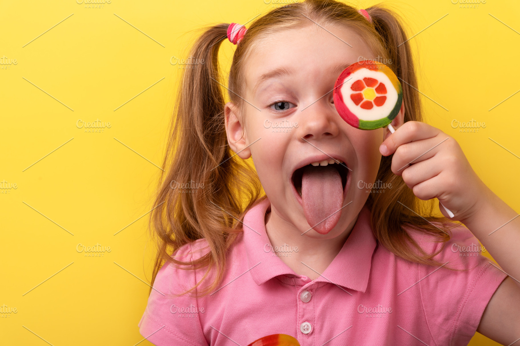 Energetic young girl sticking out her tongue and covering one ey, a Person Photo by Ales Munt