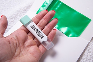 Woman Holding Stool Collection Tube for Colon Cancer Screening w, a Business Photo by MDBildes