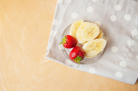 strawberry and banana on a glass plate on a wooden background., a Food & Drink Photo by Artsaba Family