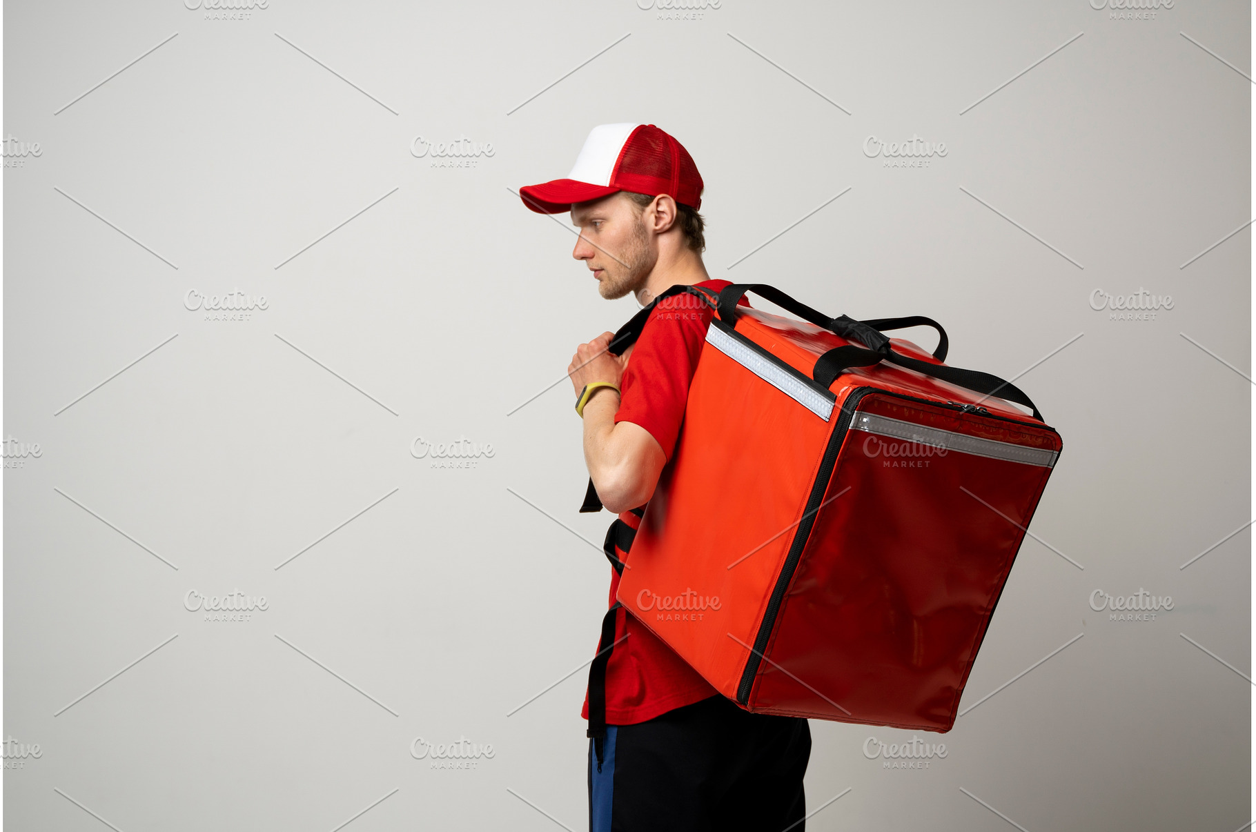 Food delivery man in red uniform, a Business Photo by volodymyrshtun13795