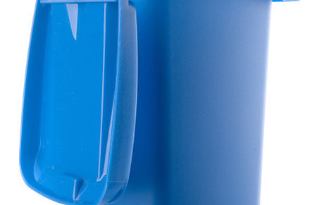 Plastic blue trash can isolated on white background