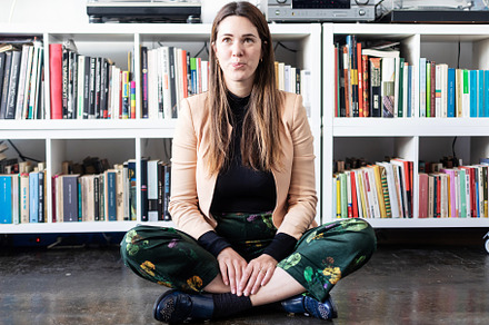 Portrait of a pretty caucasian woman sitting on home ground looking camera, a Person Photo by 2Design