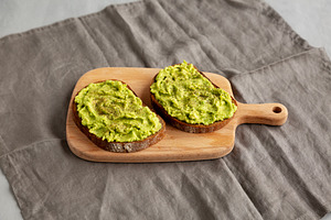 Homemade Avocado Toast with Salt and Pepper on a wooden board, s, a Food & Drink Photo by LiudmylaChuhunova