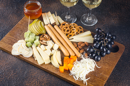 Cheese plates served with grapes, jam, snacks, crackers and nuts, a Food & Drink Photo by vimart