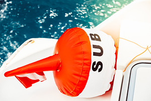 Buoy floating in ocean with vibrant, a Photo by Dvoevnore photos
