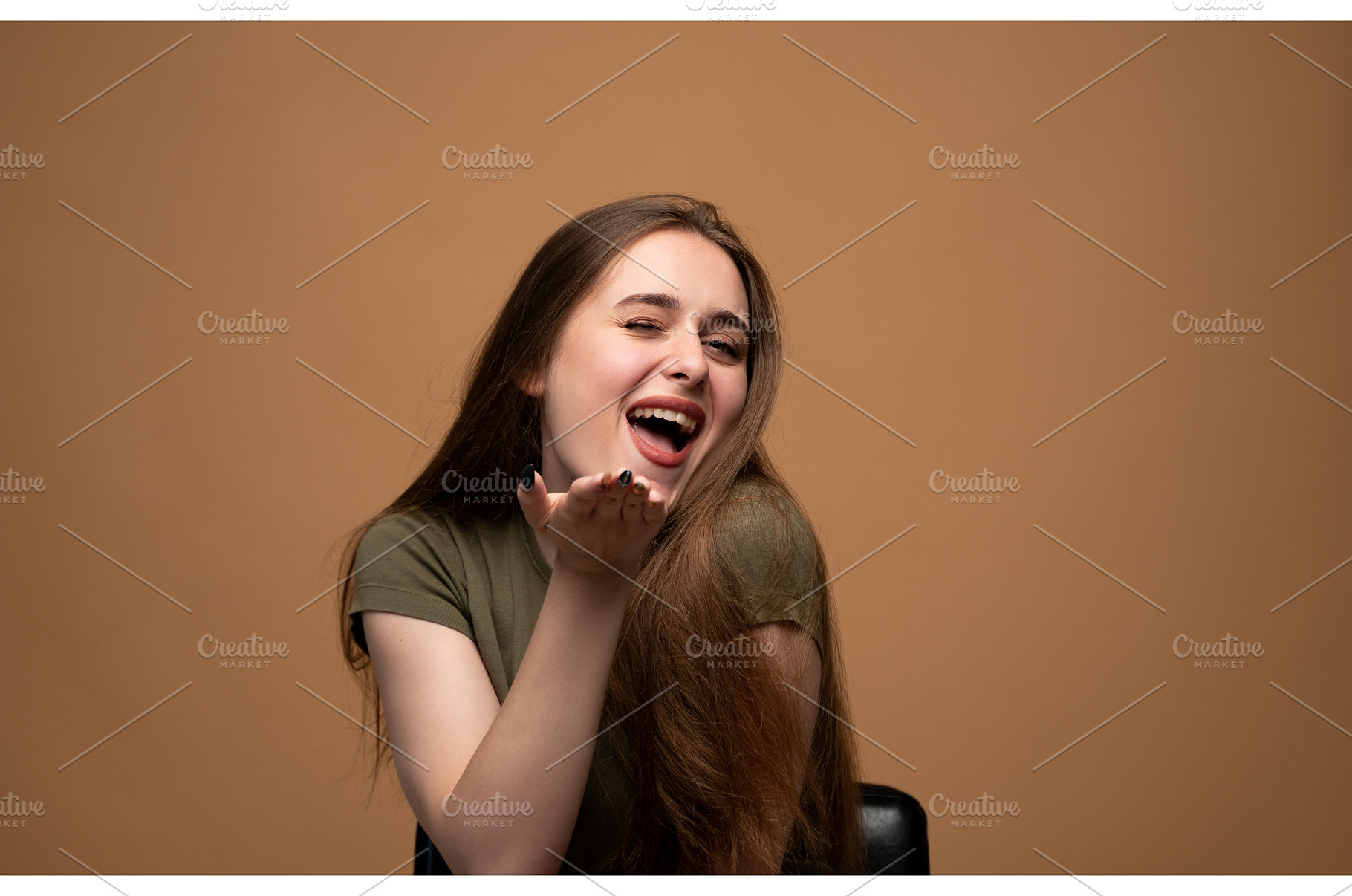 Young woman winking, smiling, and, a Person Photo by volodymyrshtun13795