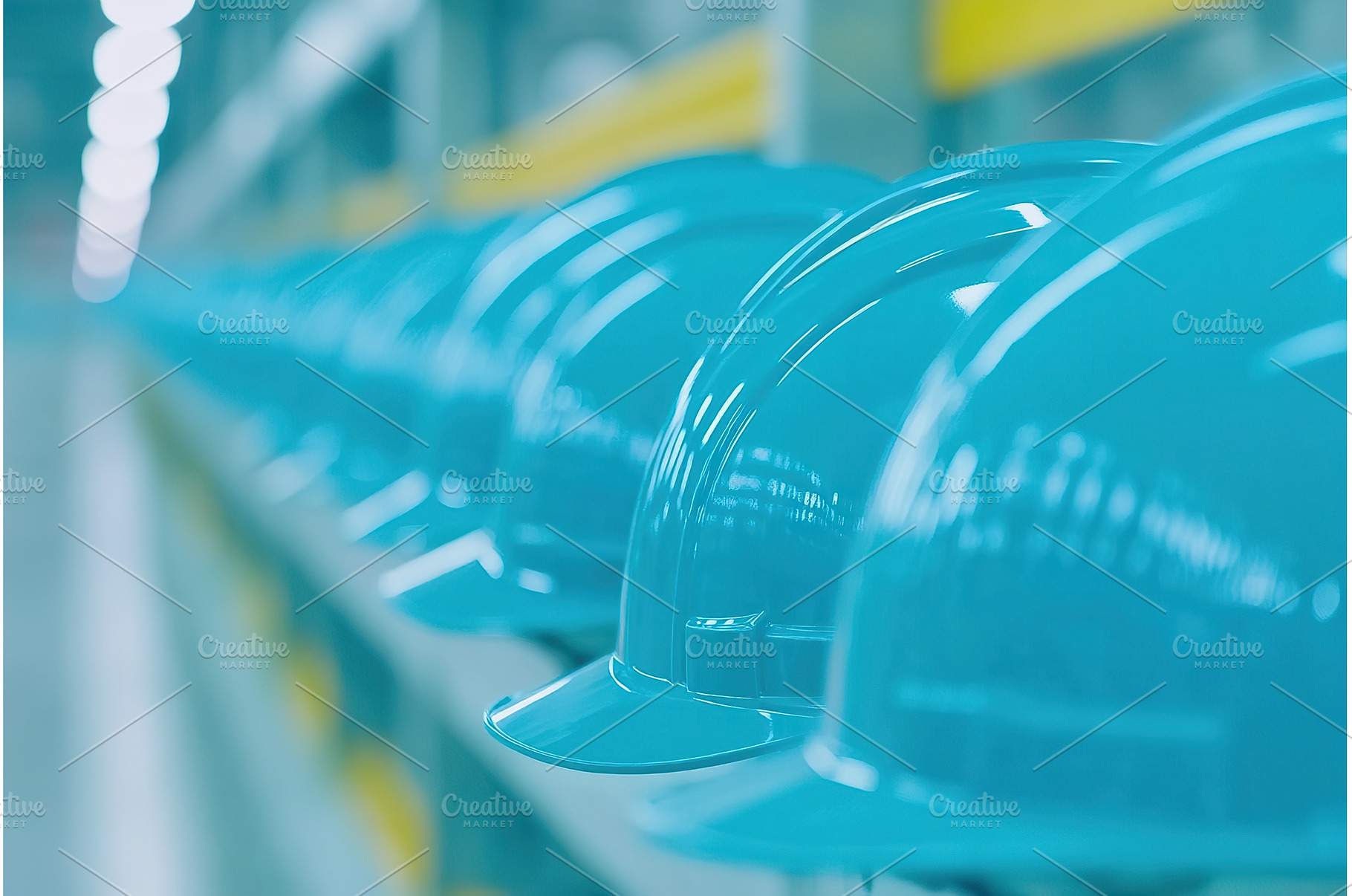 Row of blue hard hats aligned in, an Industrial Photo by Lermont51