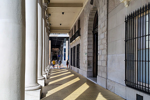 Sunlit columned corridor with shadows, an Architecture Photo by DanFLCreativo
