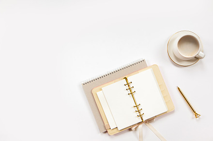Notepad and beige leather covered diary with clean sheets, gold