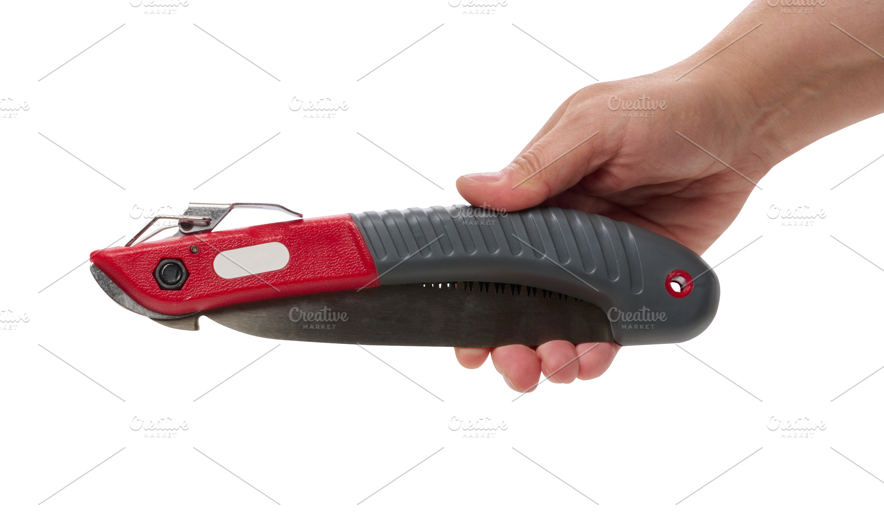 A person is holding a folding garden saw against an isolated bac, an Industrial Photo by ndanko