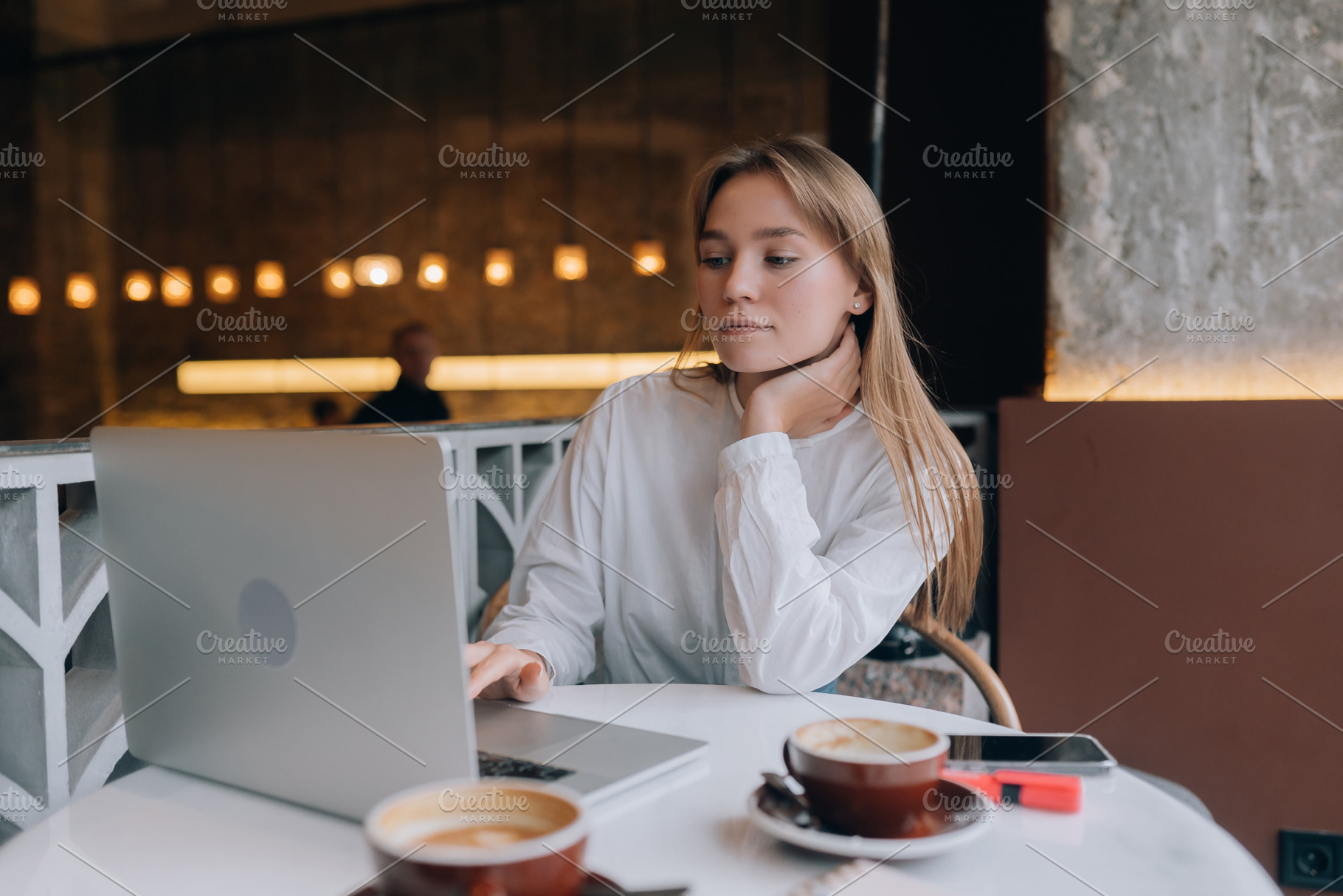 Young lady browsing the Internet at the cafe, a Person Photo by Tekso