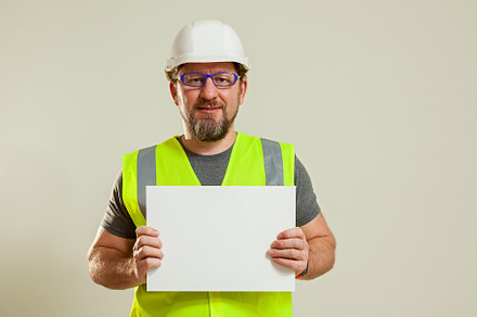 worker in a vest and white helmet, a Person Photo by Photostock