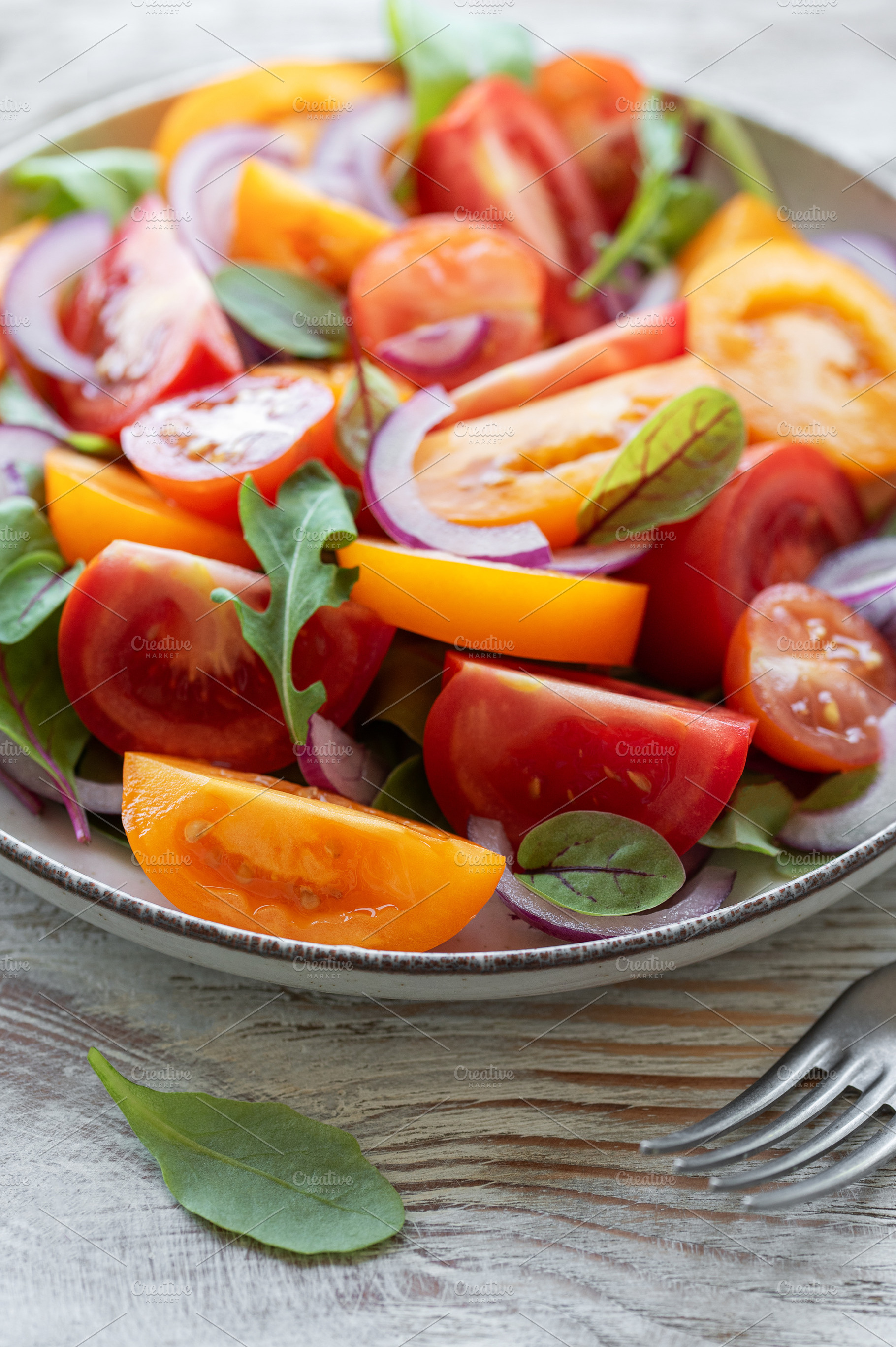 Green salad from leaves and tomatoes, a Food & Drink Photo by Olena Rudo