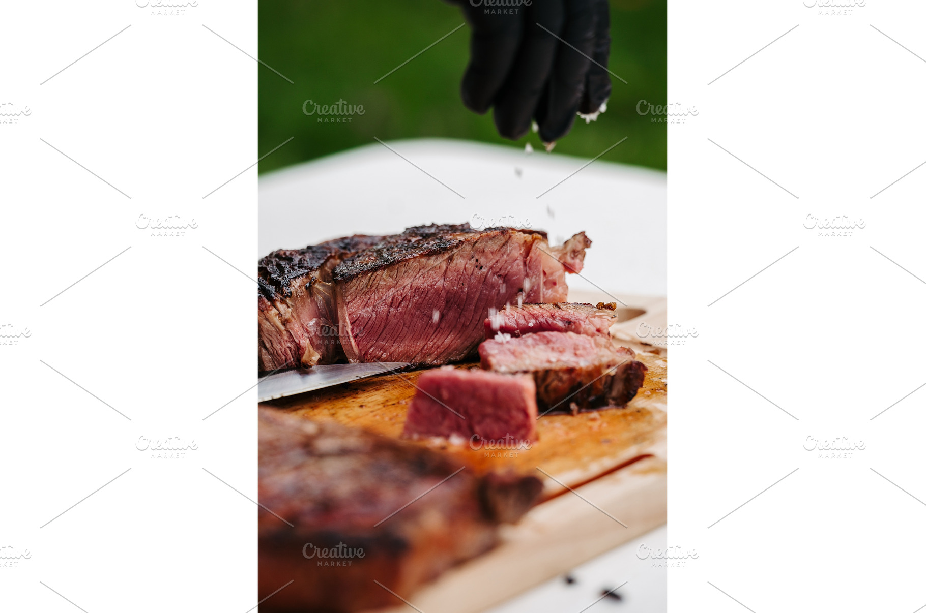Chef slicing juicy grilled steak on, a Food & Drink Photo by HalfPoint
