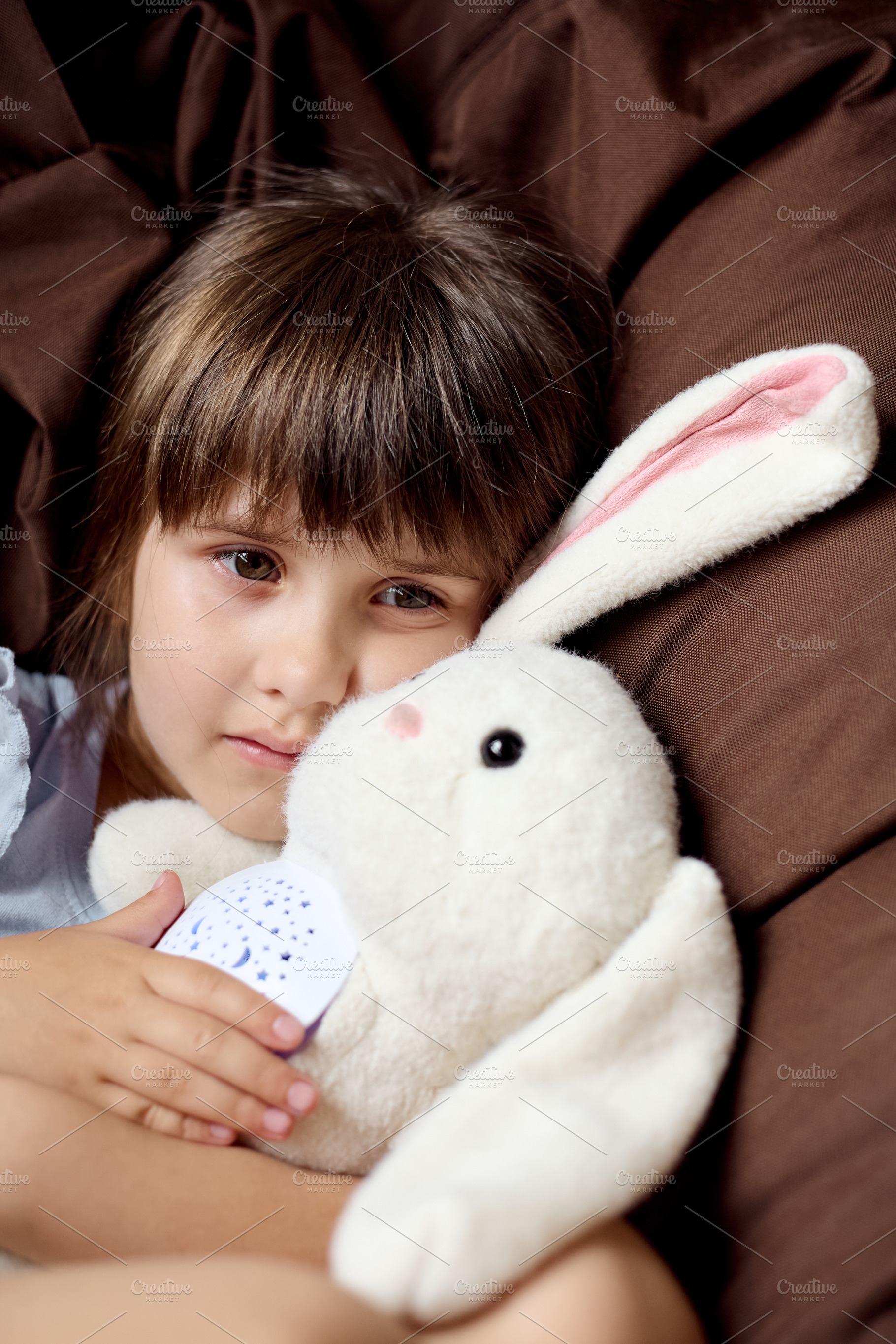 Thoughtful little girl lying in bed, a Person Photo by Rohan Photography