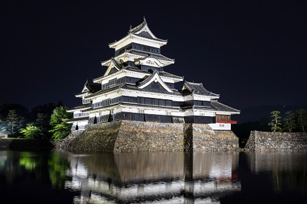 Night view of Matsumoto Castle reflecting in the water, Japan