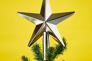 Christmas tree ornament on yellow ba stock photo containing yellow background
