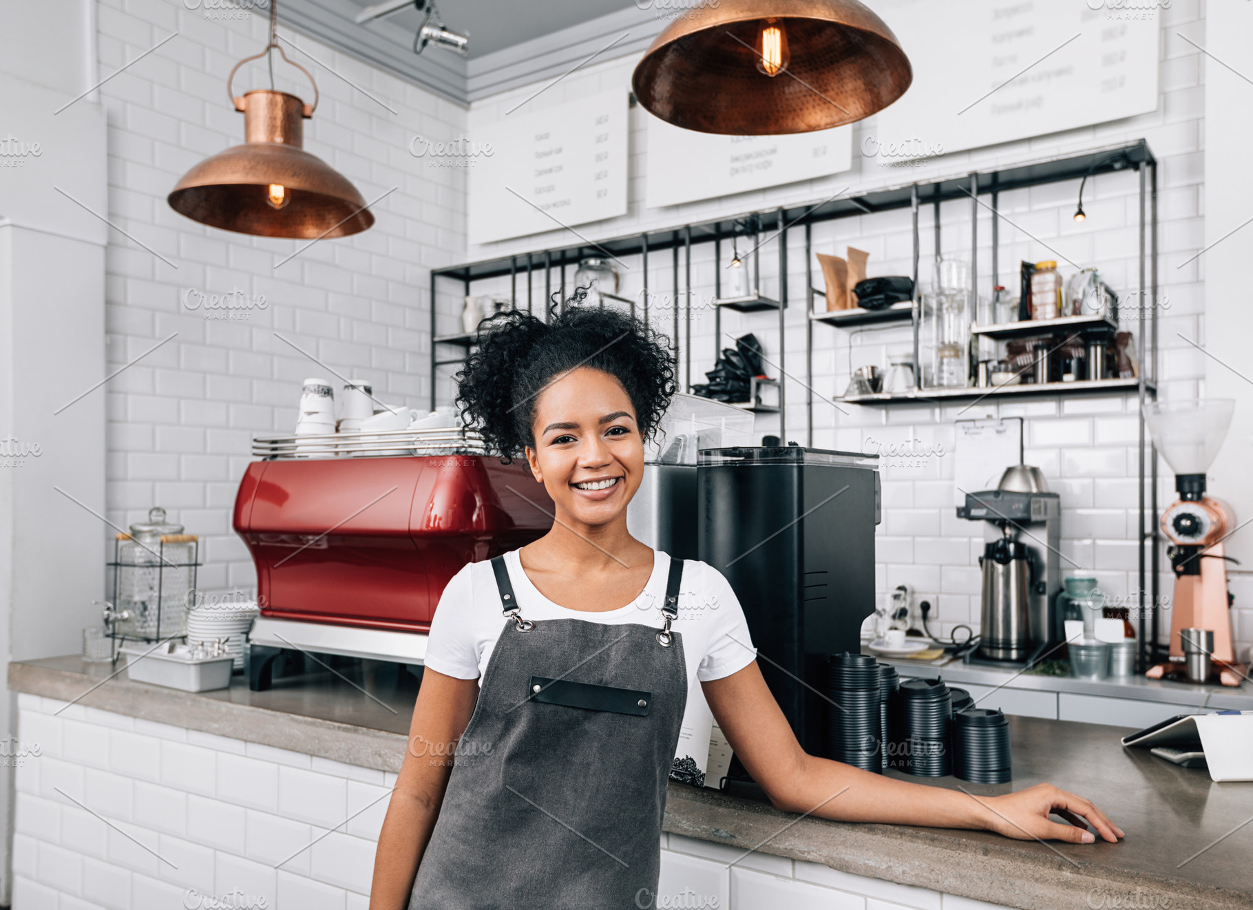 Young smiling woman with curly hair, a Business Photo by Artem Varnitsin