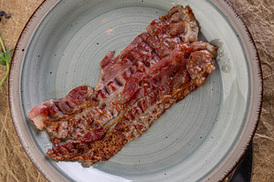 Fried bacon piece for breakfast, a Photo by Grafvision photography