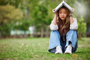 Study, sad and book with woman in park for studying, thinking or depression mockup. College, mental health and education with asian student on grass in nature for burnout, anxiety and fatigue problem, a Photo by Peopleimages.com