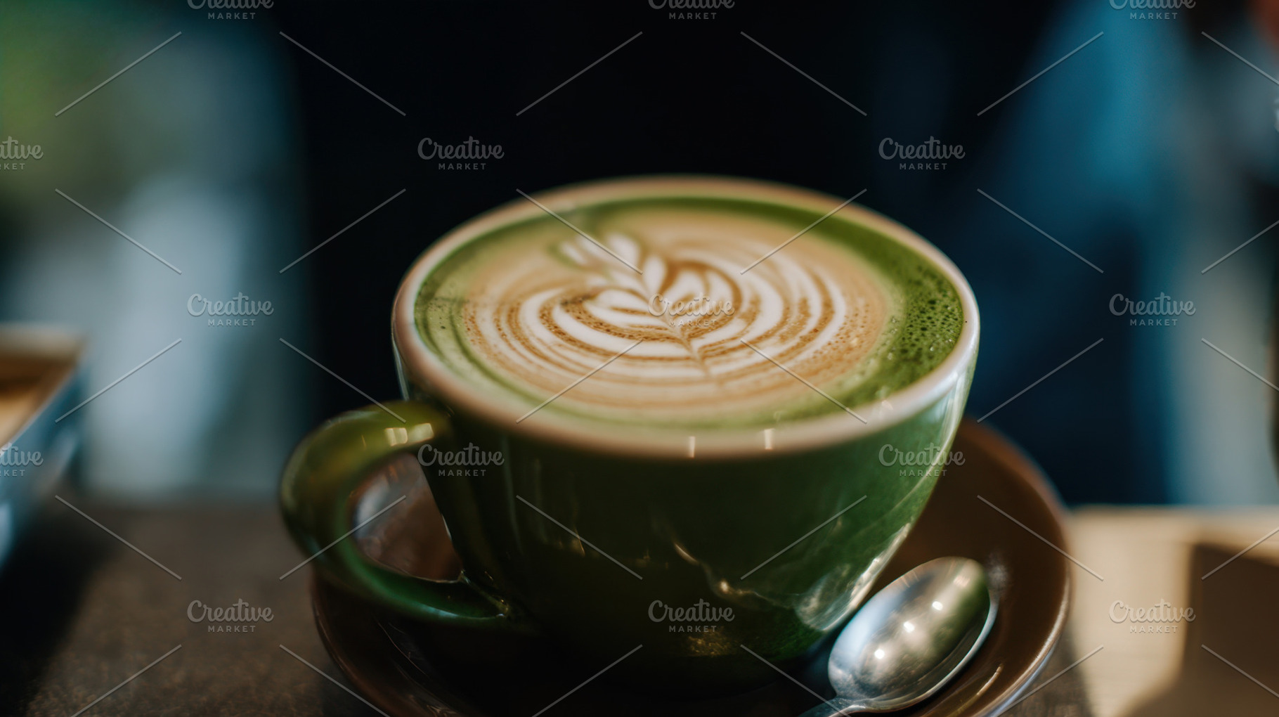 Coffee in green cup with design, a Photo by Beautiful things
