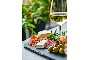 Elegant charcuterie board with wine, a Food & Drink Photo by Lermont51