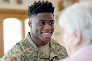 Young african american soldier smiling at elderly woman in cozy, a Photo by Dvoevnore photos