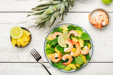 Pineapple shrimp salad with spinach, avocado and lime on white w, a Food & Drink Photo by 5PH